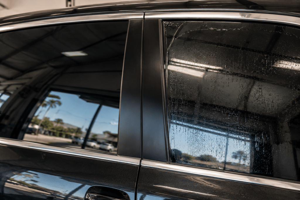 Close-up comparison of smooth professional car window tint and poor tint with visible imperfections